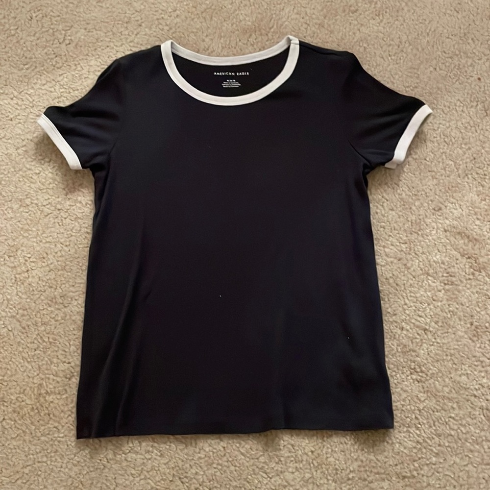 Womens navy short sleeve shirt with a white collar and white sleeve border.